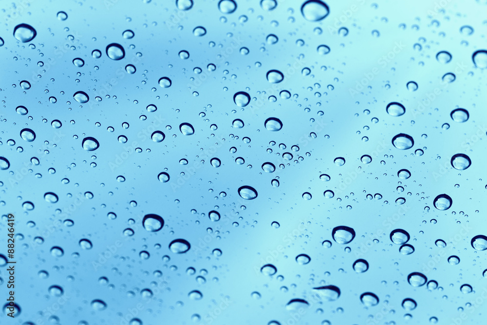 Rainy water drop on glass mirror background.