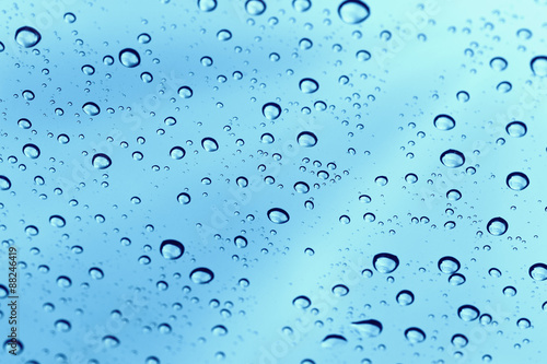 Rainy water drop on glass mirror background.