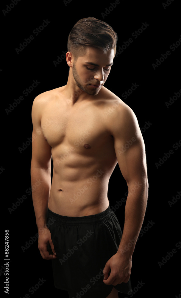 Muscle young man on dark background Muscle young man on dark background