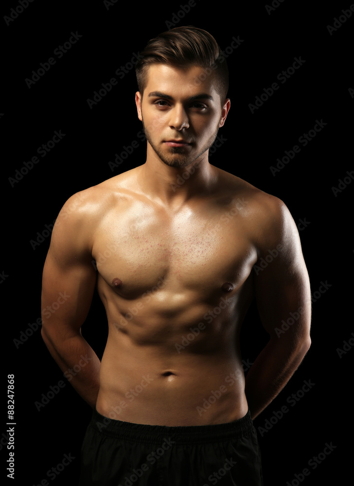 Fototapeta premium Muscle young man on dark background