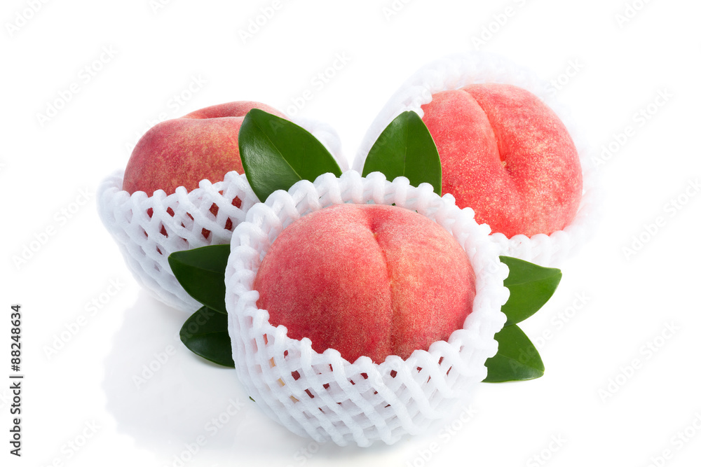 Ripe peach fruits with green leaves isolated on white background Ripe peach fruits with green leaves isolated on white background