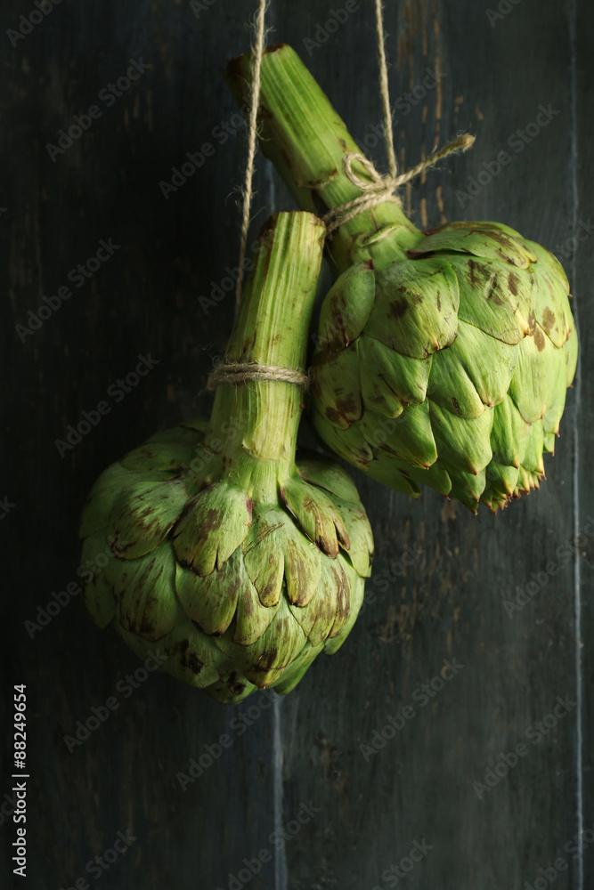 Fototapeta premium Artichokes on color wooden background