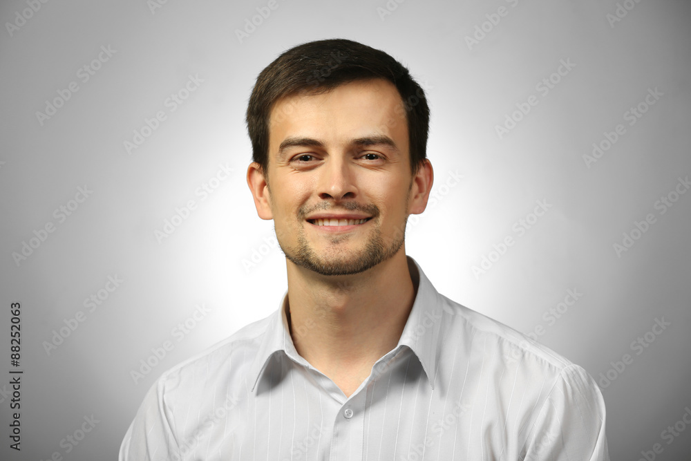 Handsome young man on gray background Handsome young man on gray background