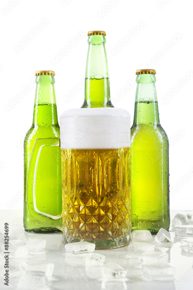 Lager with foam in the glass and bottles