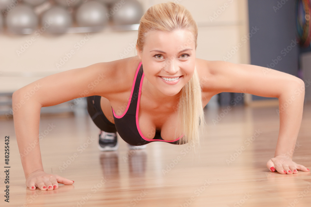 Nice woman doing push ups in gym Nice woman doing push ups in gym