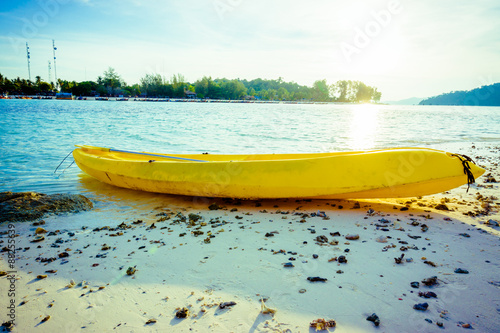 Colorful yellow kayaks on beach in Andaman sea photo