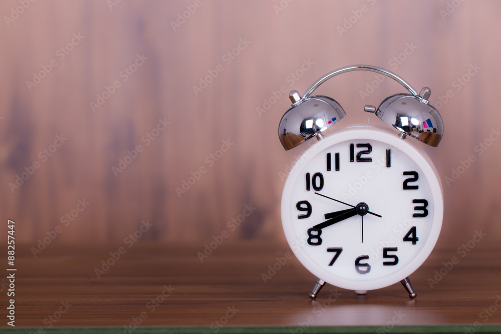 white alarm clock on wooden old background, red vintage clock on white alarm clock on wooden old background, red vintage clock on