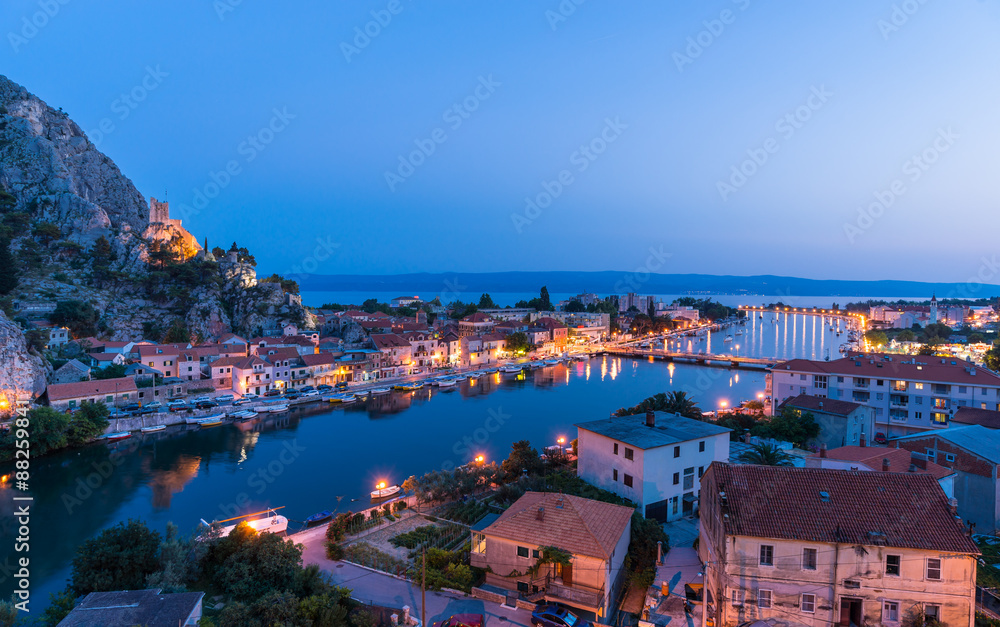 Omis Landscape at sunset with the moon. The city is lit by elect