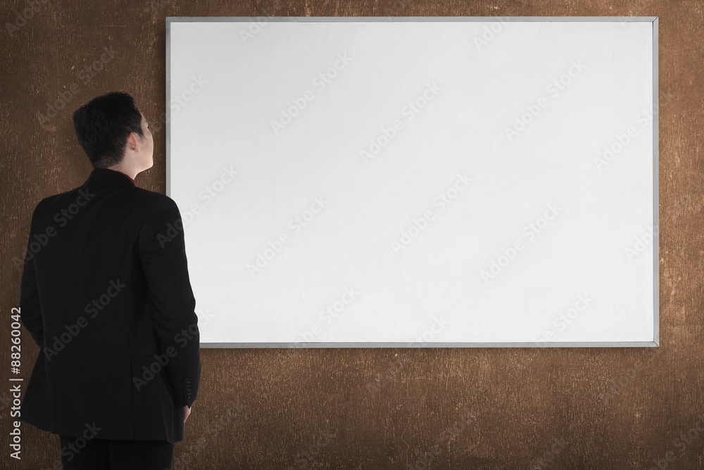 Back view young man with white board Back view young man with white board