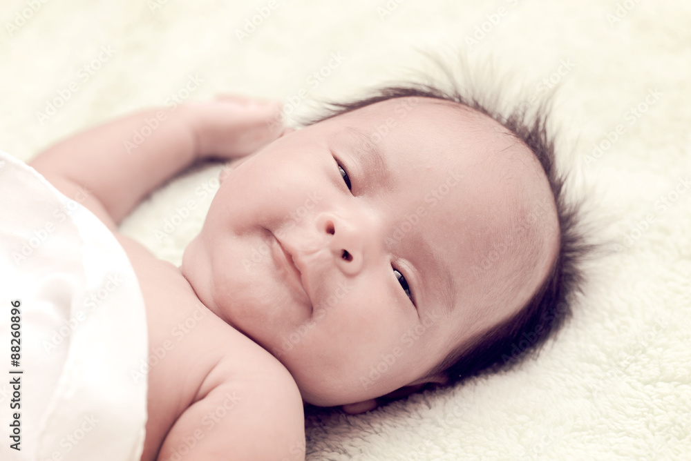 Peaceful baby lying on a bed while sleeping in a bright room Peaceful baby lying on a bed while sleeping in a bright room