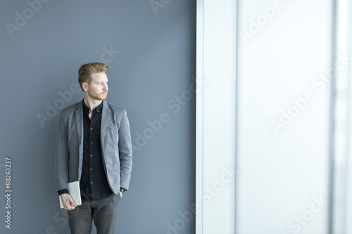 Young man with tablet by th...