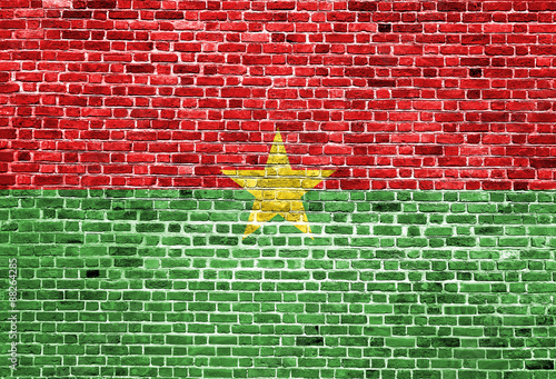 Flag of Burkina Faso painted on brick wall, background texture