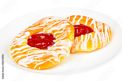 Delicious danish pastry on a plate, isolated on white background