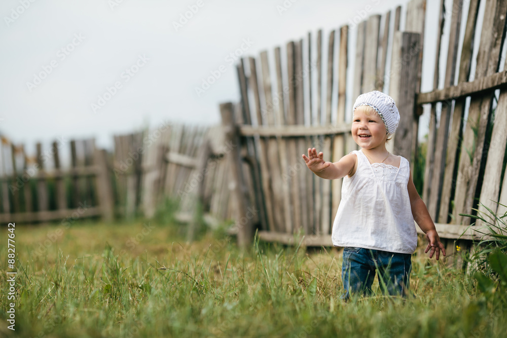 little girl and wooden fence