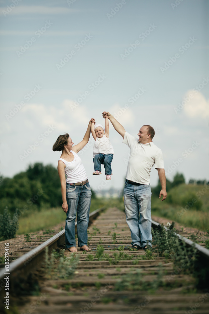 parents with baby on railroad parents with baby on railroad