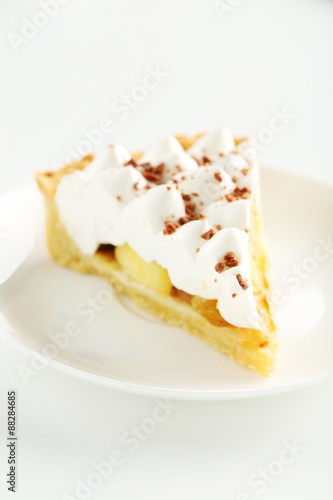Apple cake with meringue on white plate