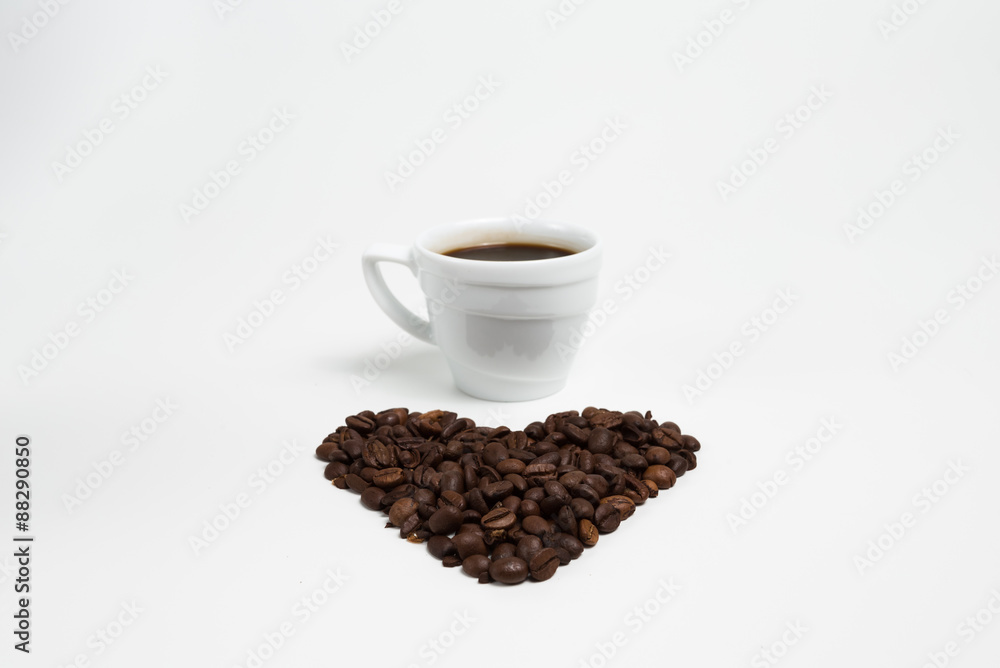 Cup coffee on a Heart shape made from coffee on white background Cup coffee on a Heart shape made from coffee on white background