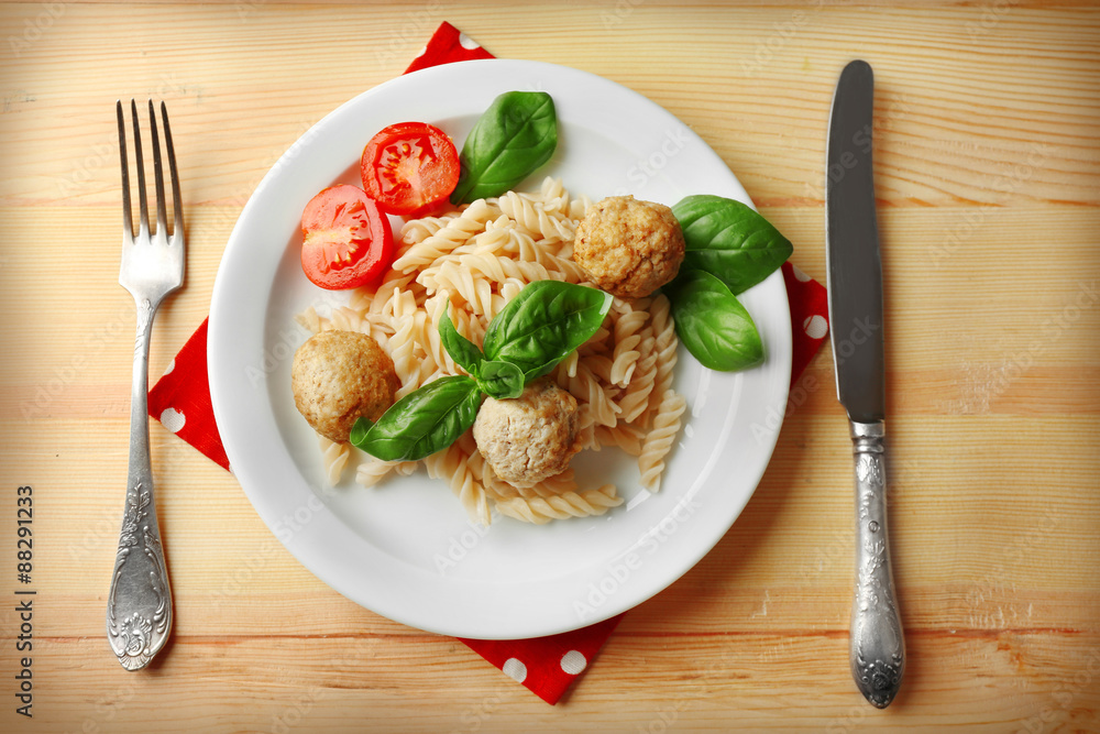 Pasta with meatballs on plate, on wooden table background Pasta with meatballs on plate, on wooden table background