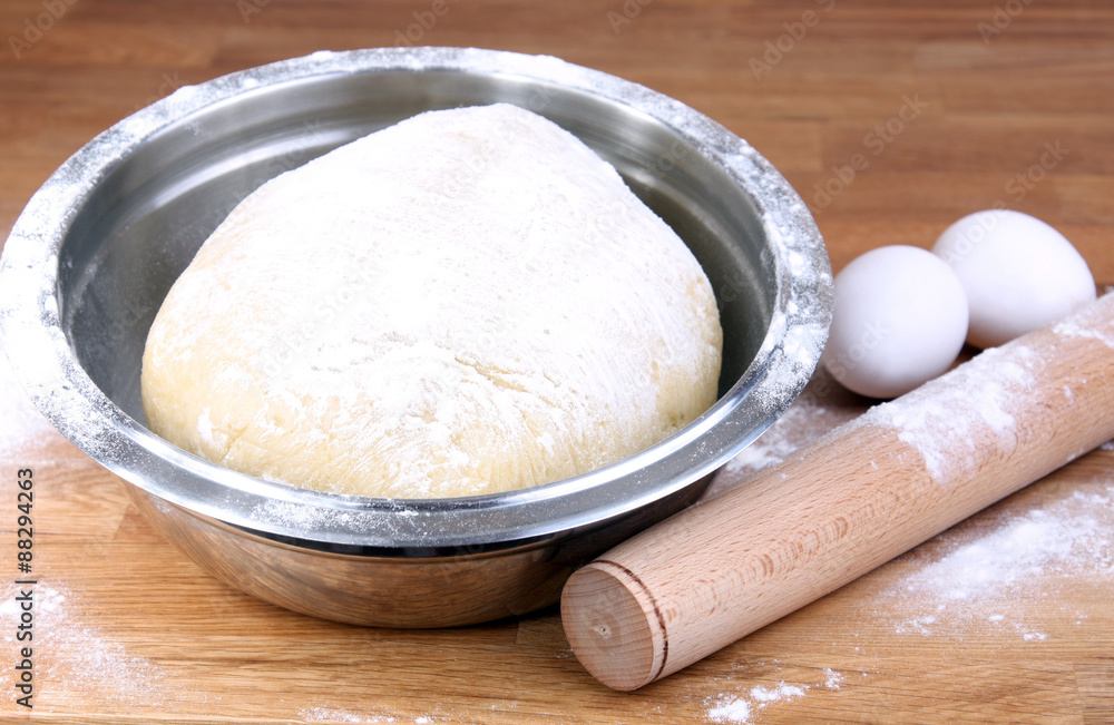 pastry baking: dough in bowl, rolling pin, flour and eggs
pastry baking: dough in bowl, rolling pin, flour and eggs