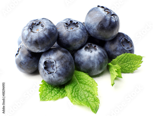 Fresh blueberries with mint leaves isolated on white