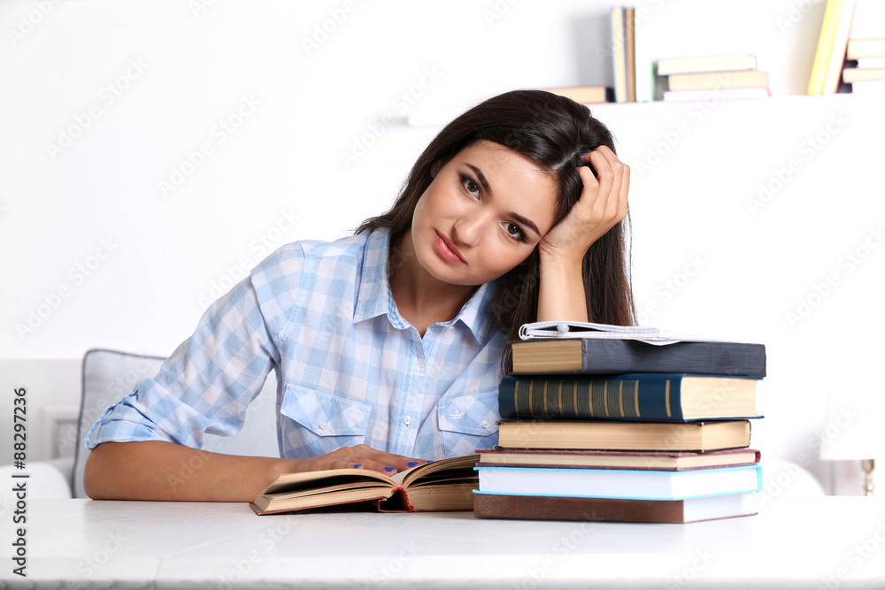 Young girl reading book in room Young girl reading book in room