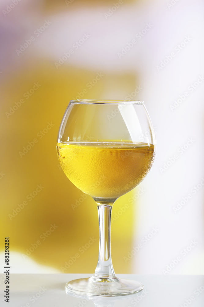 Glass of wine on light blurred background Glass of wine on light blurred background