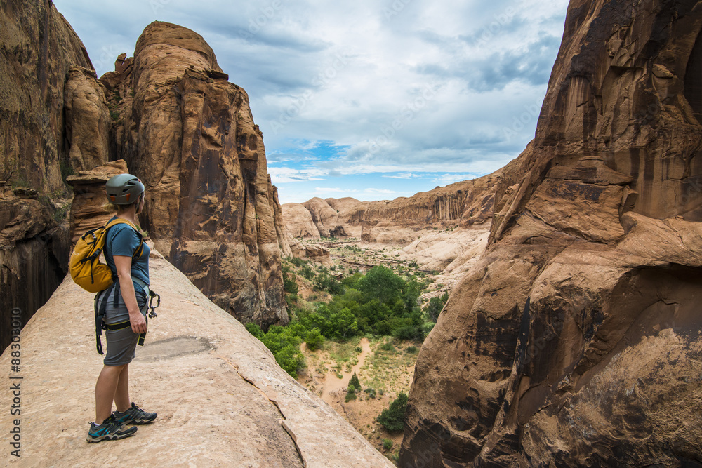 Woman standing on a giant arch near Moab, Utah Woman standing on a giant arch near Moab, Utah