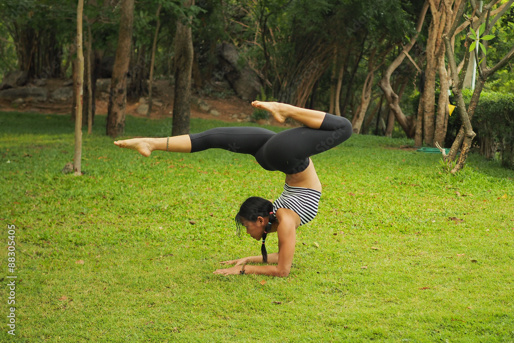 Young woman doing yoga exercises in the garden park Young woman doing yoga exercises in the garden park