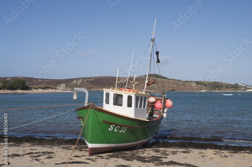 Fishing boat on Bryer with Tresco in background, Isles of Scilly photo