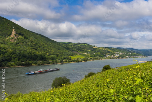 Cargo boat passing Castle Sooneck on the River Rhine, Niederheimbach. Upper Rhine Valley, Hesse, Germany photo