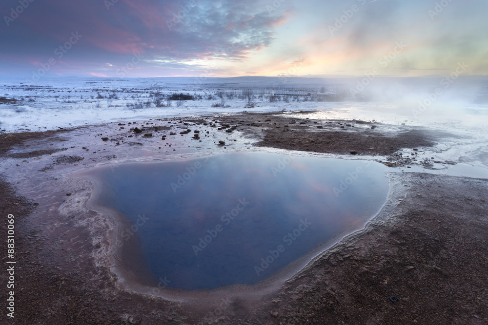 Steam rising from geothermal pools at sunrise in winter, Geysir, Haukardalur Valley, Iceland Steam rising from geothermal pools at sunrise in winter, Geysir, Haukardalur Valley, Iceland