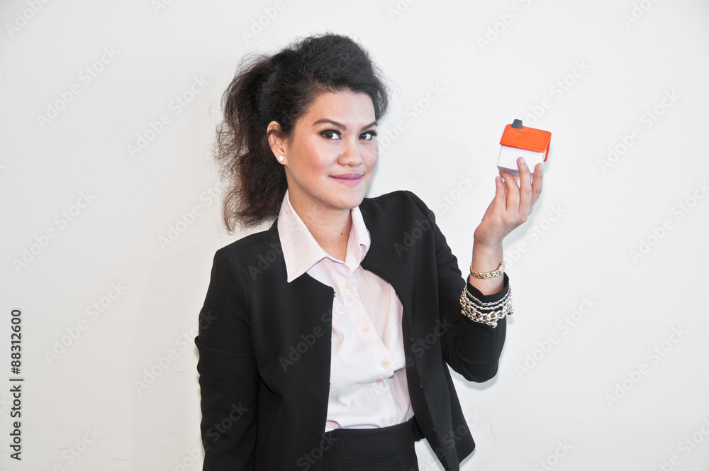 Business woman hold house toy model on white background Business woman hold house toy model on white background