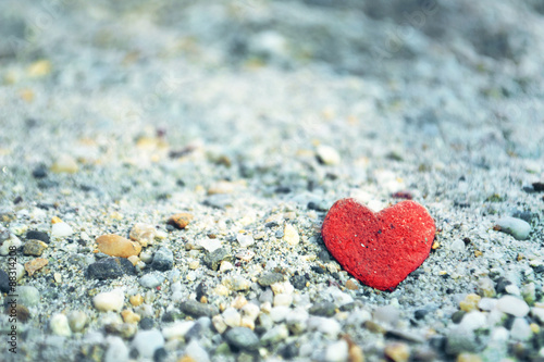 Heart shaped stone on the sand. Love concept