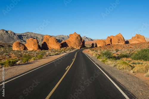 Road leading in the redrock sandstone formations of the Valley of Fire State Park, Nevada photo
