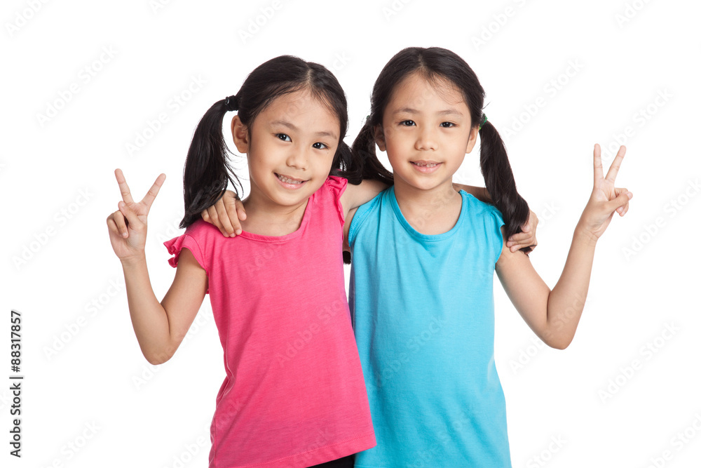 Happy Asian twins girls smile show victory sign Happy Asian twins girls smile show victory sign