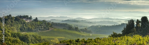Early morning panoramic view of misty hills, near San Gimignano, Tuscany