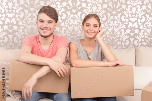 Cheerful couple holding boxes  photo