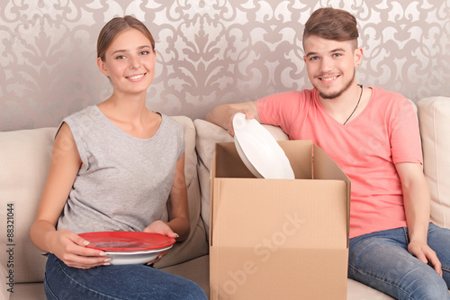 Nice couple opening boxes  photo