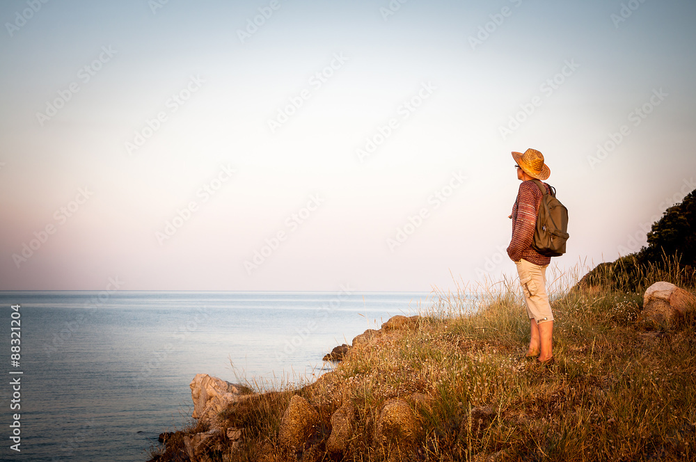 Woman on the top of the mountain in the sunset  