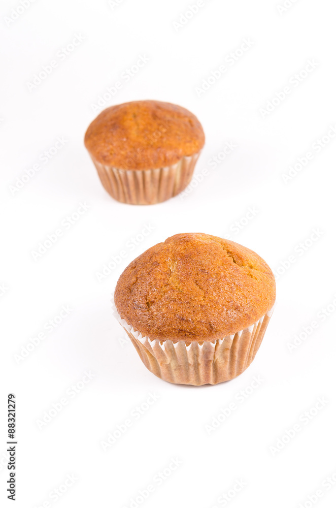 Two brown banana muffin in paper cupcake holder isolated on whit Two brown banana muffin in paper cupcake holder isolated on whit