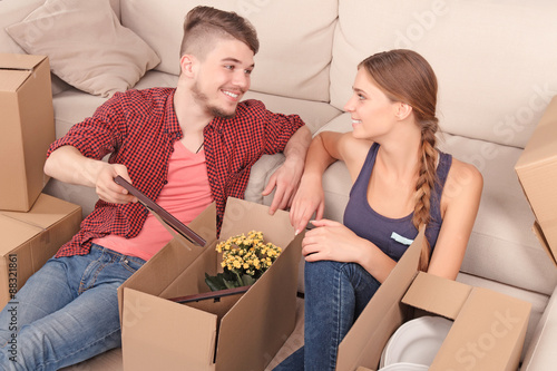 Young couple unpacking boxes  photo