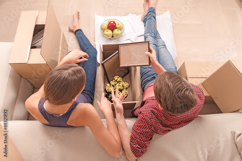 Young couple unpacking boxes  photo