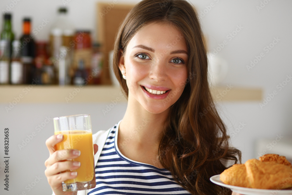 Young woman with glass of juice and cakes Young woman with glass of juice and cakes