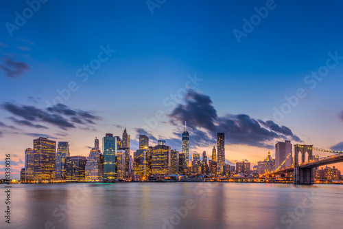 Brooklyn bridge and downtown New York City in beautiful sunset