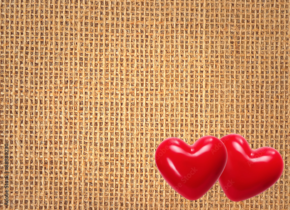 Linen texture background with two red hearts