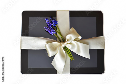Digital tablet with white ribbon isolated on white background