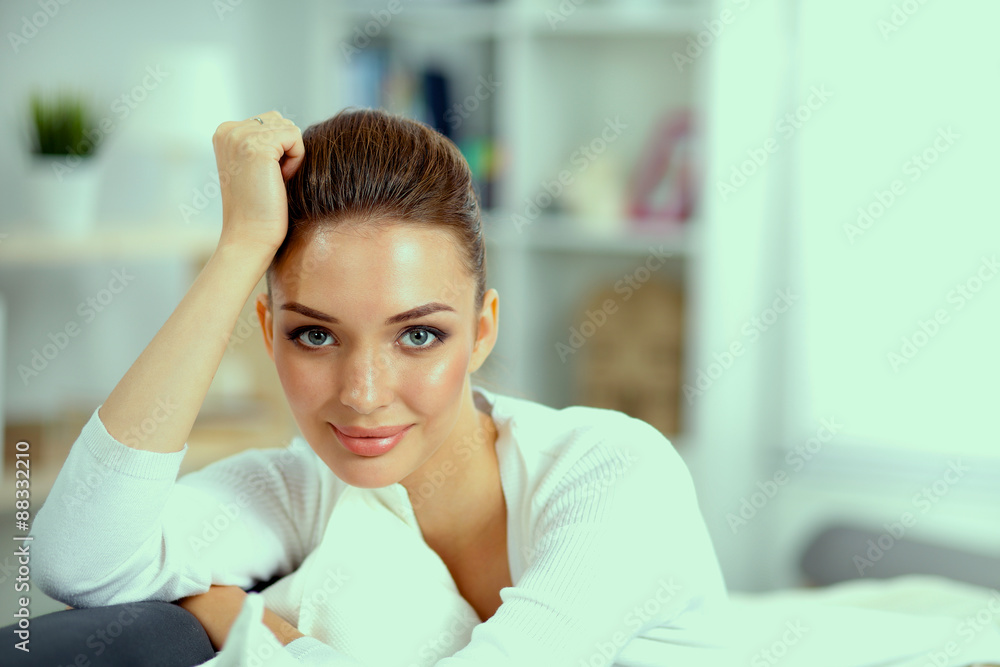 Young beautiful woman sitting on couch at her room Young beautiful woman sitting on couch at her room