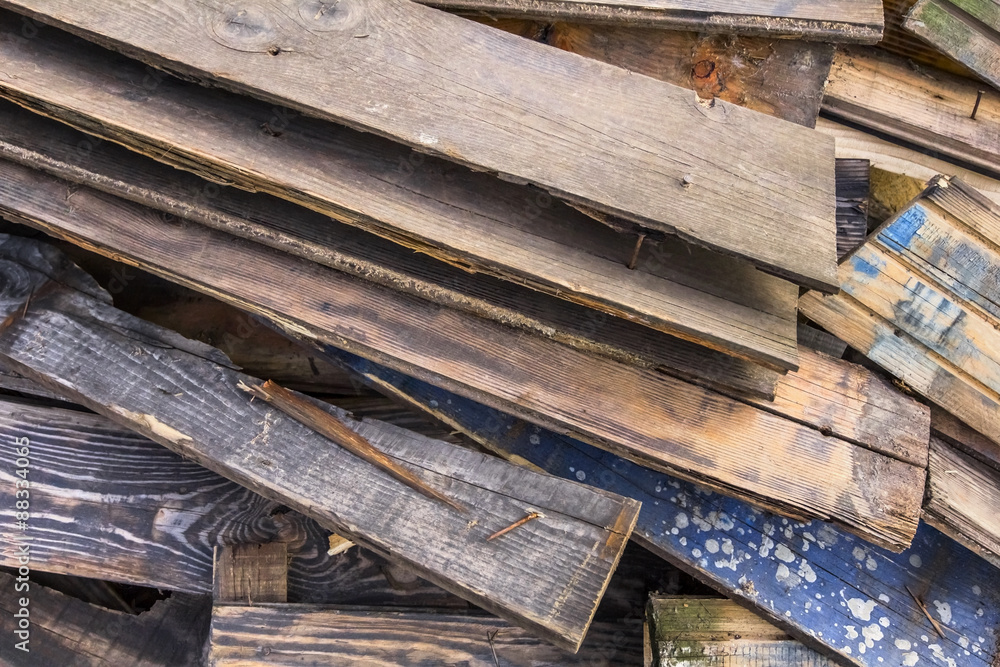 Photograph of old, rotten, scrapped floorboards and decking planks amassed and scattered in a untidy heap. Photograph of old, rotten, scrapped floorboards and decking planks amassed and scattered in a untidy heap.