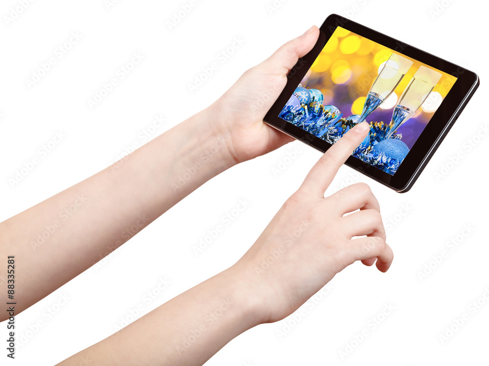 hand touches tablet pc with Xmas still life hand touches tablet pc with Xmas still life