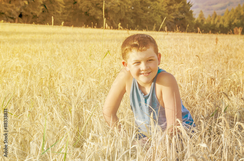happy kid in wheat field.